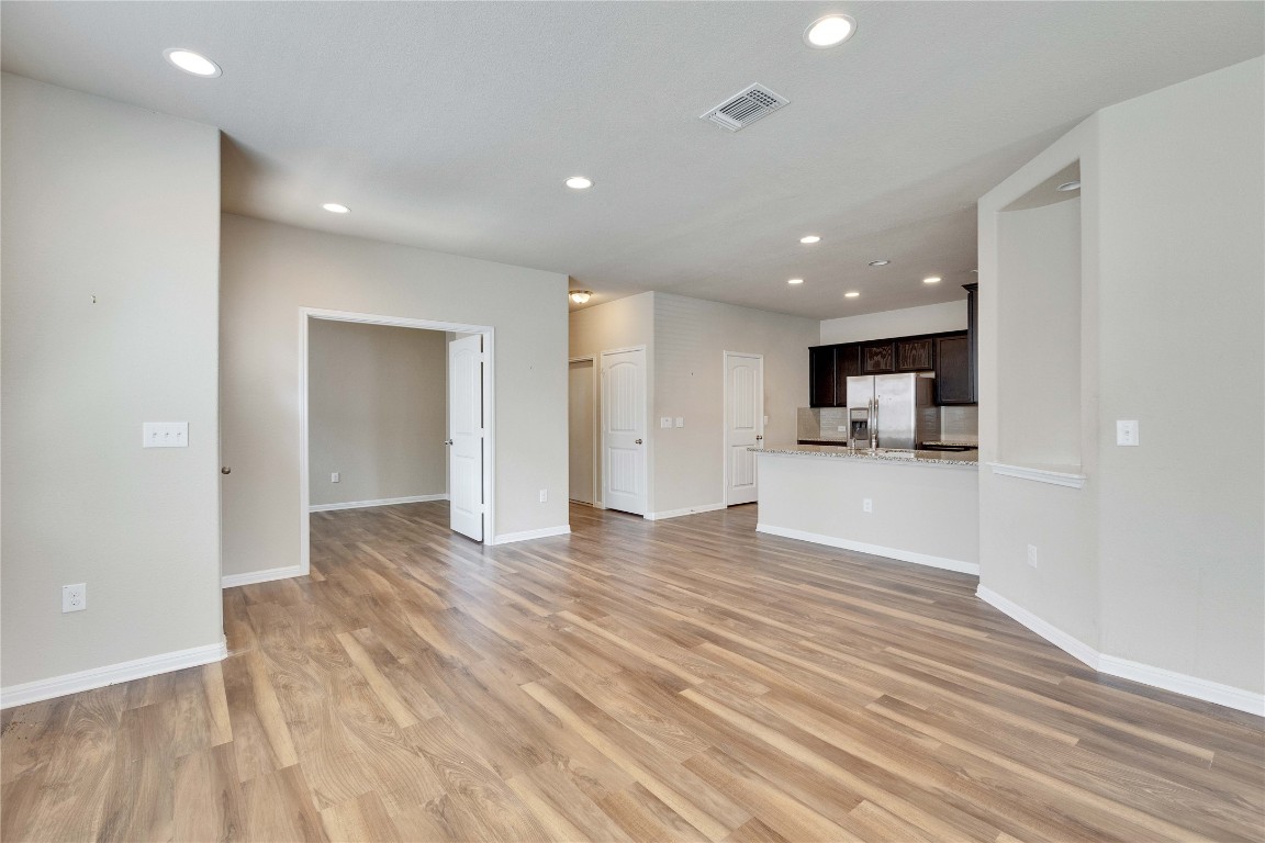 1701 Logan Drive, Unit 12 Round Rock, TX 78664 - Photo 11 of 26 a view of empty room with wooden floor