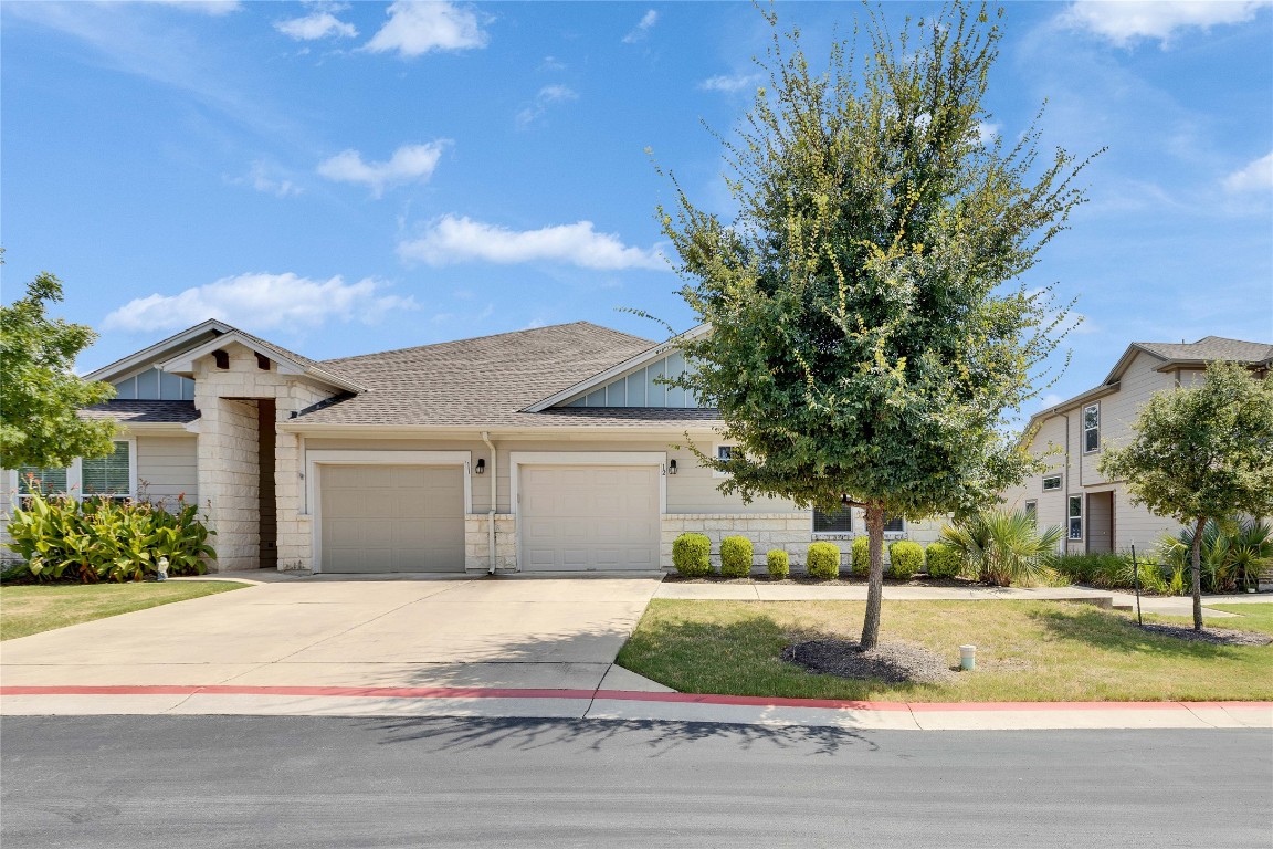 1701 Logan Drive, Unit 12 Round Rock, TX 78664 - Photo 2 of 26 a front view of a house with garden