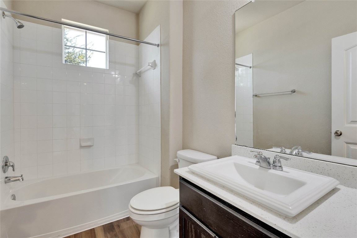 1701 Logan Drive, Unit 12 Round Rock, TX 78664 - Photo 23 of 26 a bathroom with a sink toilet and shower