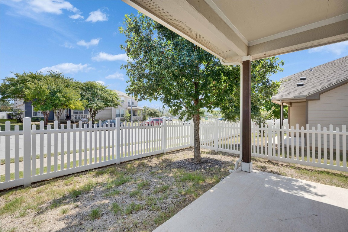 1701 Logan Drive, Unit 12 Round Rock, TX 78664 - Photo 24 of 26 a view of a house with a small yard and wooden fence