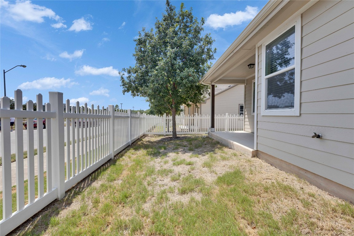 1701 Logan Drive, Unit 12 Round Rock, TX 78664 - Photo 26 of 26 a view of a house with a small yard and wooden fence