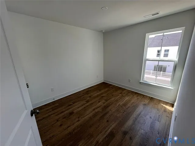 a view of an empty room and wooden floor
