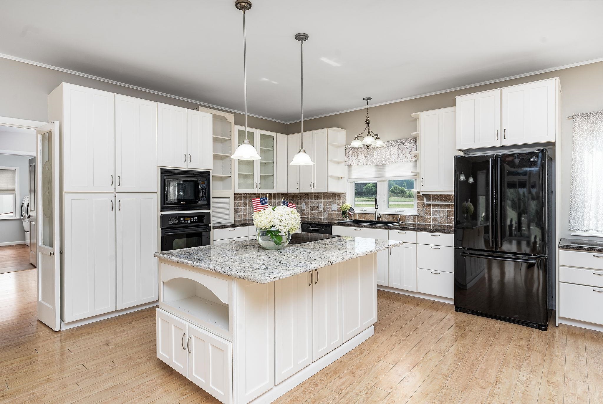 1373 Rockfish Road Waynesboro, VA 22980 - Photo 13 of 75 a kitchen with kitchen island white cabinets and refrigerator
