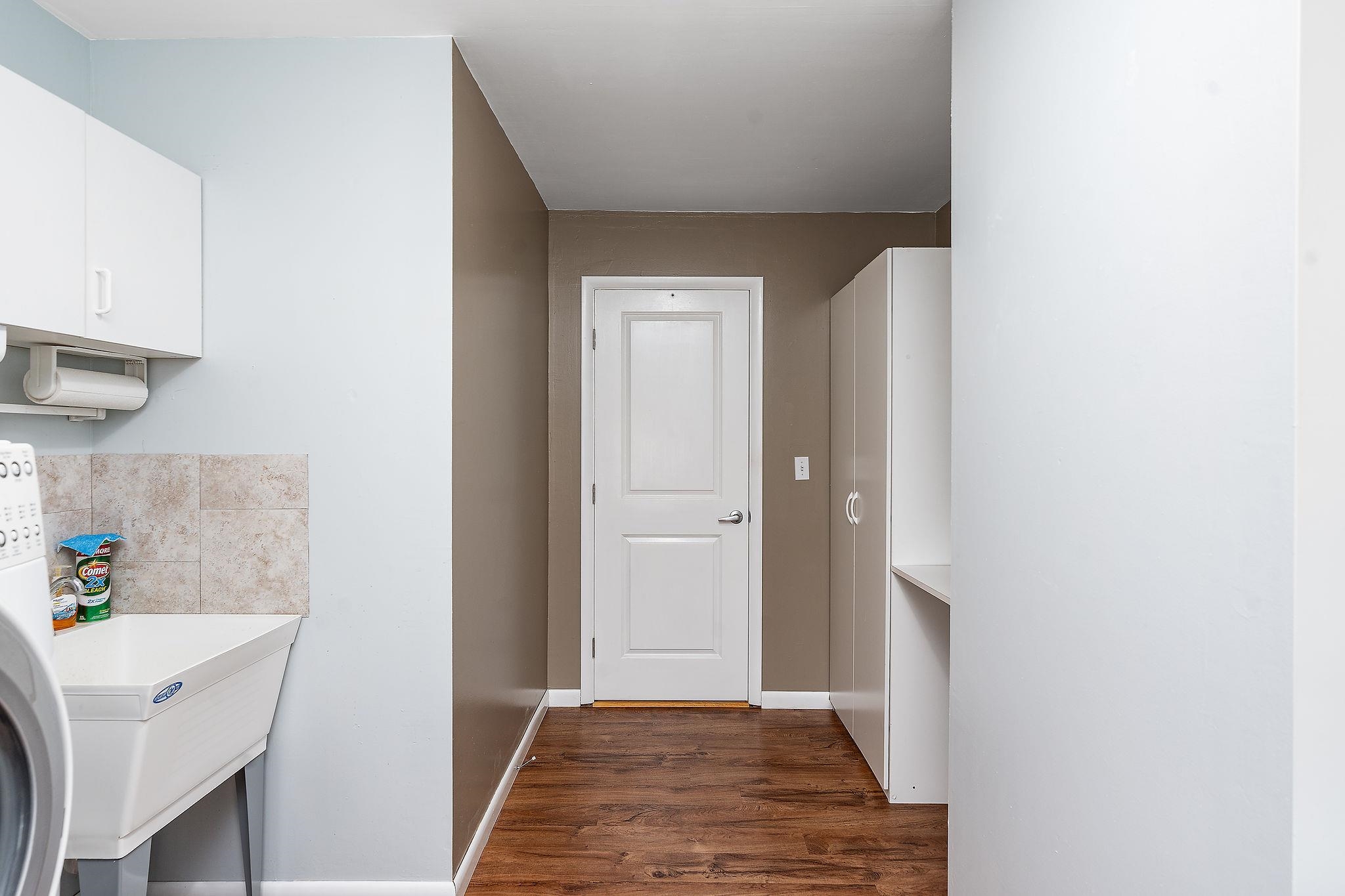 1373 Rockfish Road Waynesboro, VA 22980 - Photo 26 of 75 a view of a hallway to a livingroom with wooden floor and a refrigerator