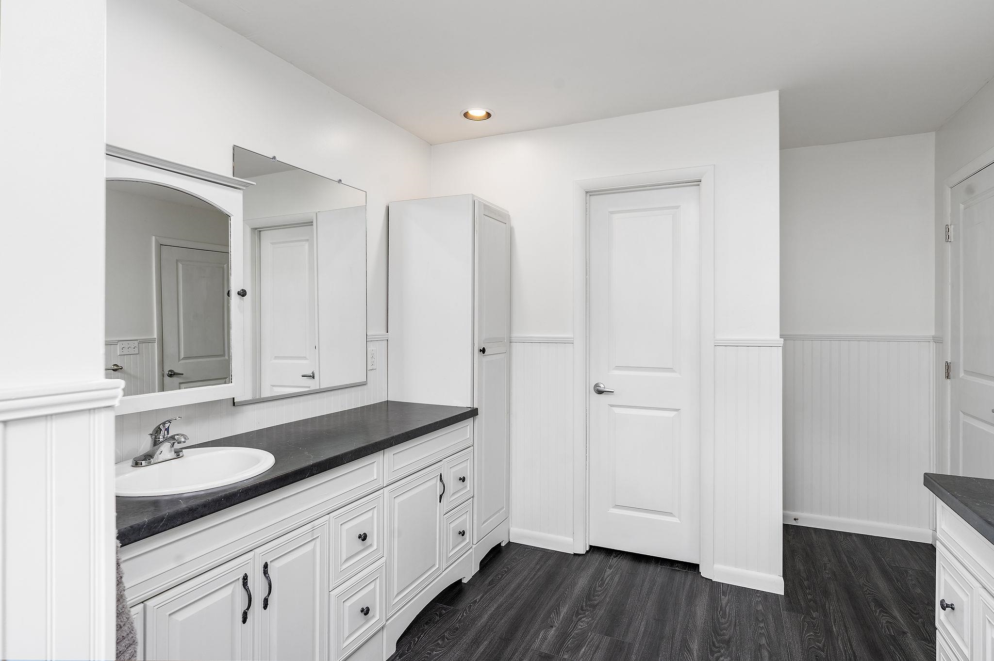 1373 Rockfish Road Waynesboro, VA 22980 - Photo 36 of 75 a spacious bathroom with a granite countertop sink and a mirror