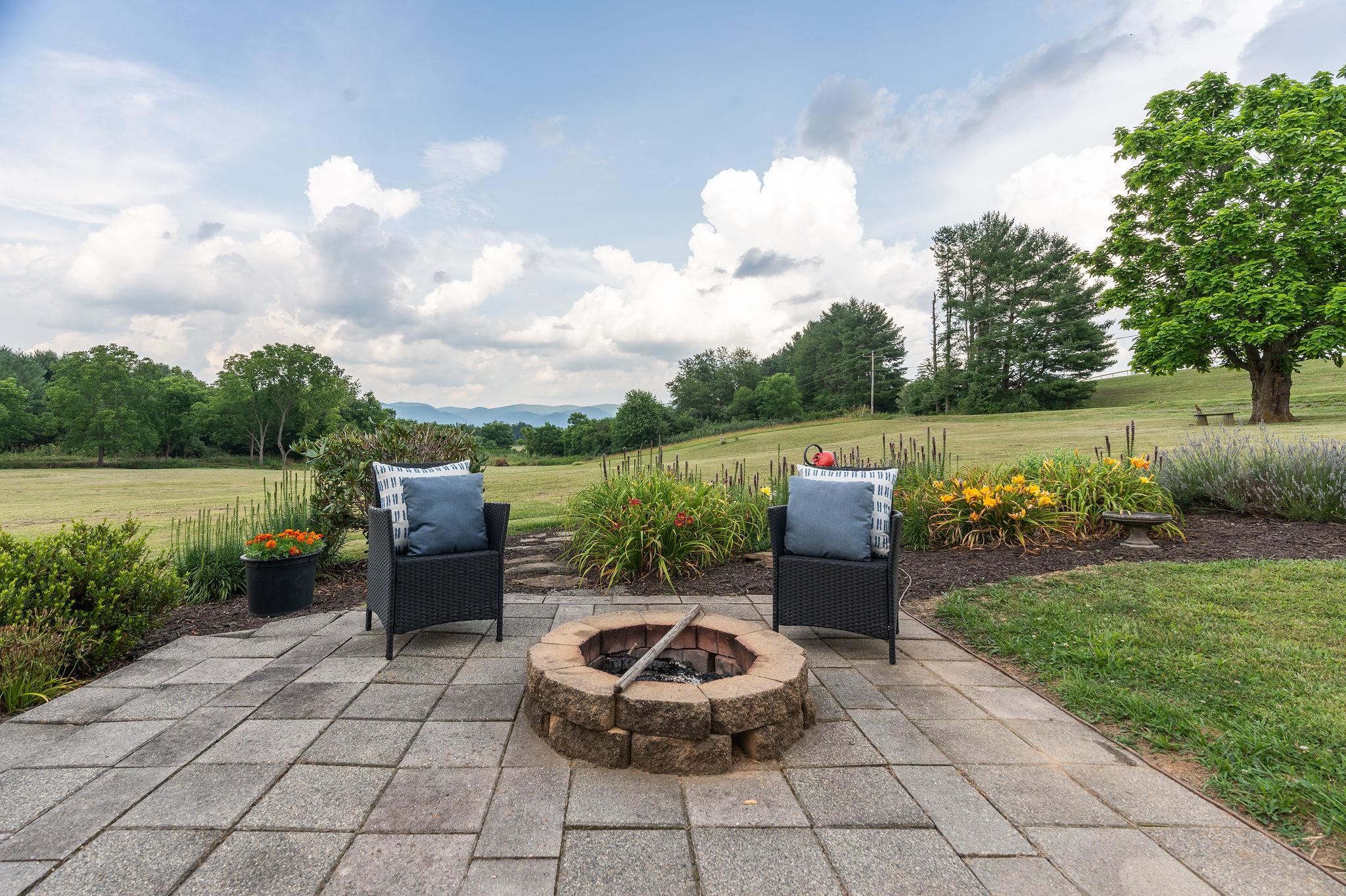 1373 Rockfish Road Waynesboro, VA 22980 - Photo 60 of 75 a backyard view with a garden and barbeque oven