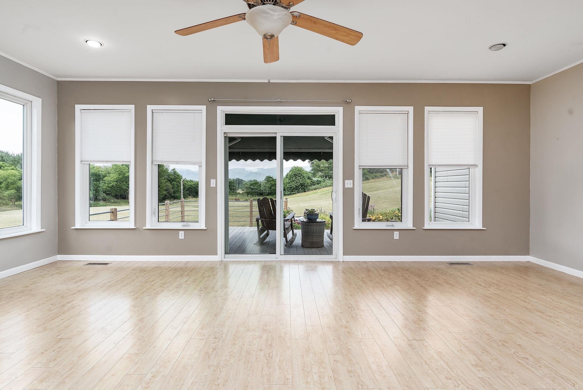 1373 Rockfish Road Waynesboro, VA 22980 - Photo 6 of 75 a view of an empty room with a window and wooden floor