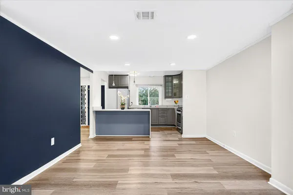 a kitchen with stainless steel appliances kitchen island wooden cabinets and granite counter tops