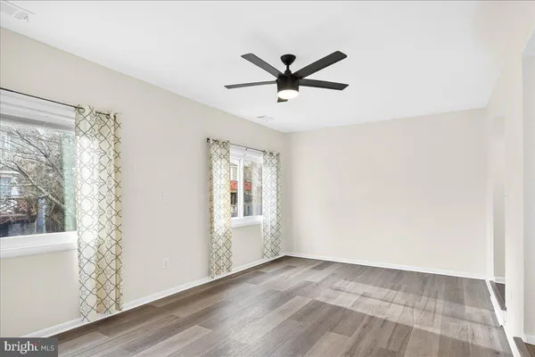 a view of a livingroom with a window and wooden floor