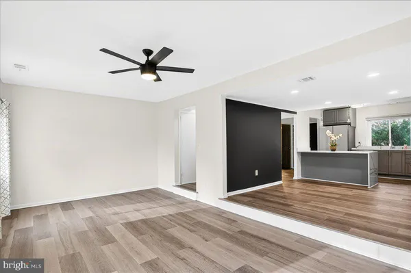 a view of a livingroom with a ceiling fan and window