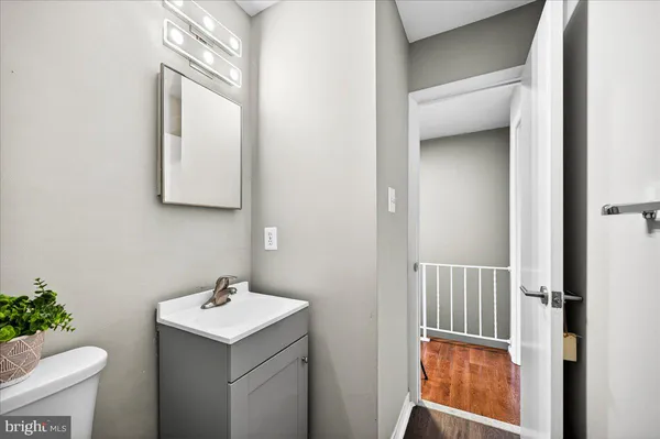 a bathroom with a sink toilet and mirror