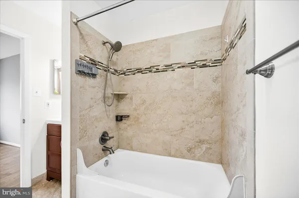 a bathroom with a bathtub and shower