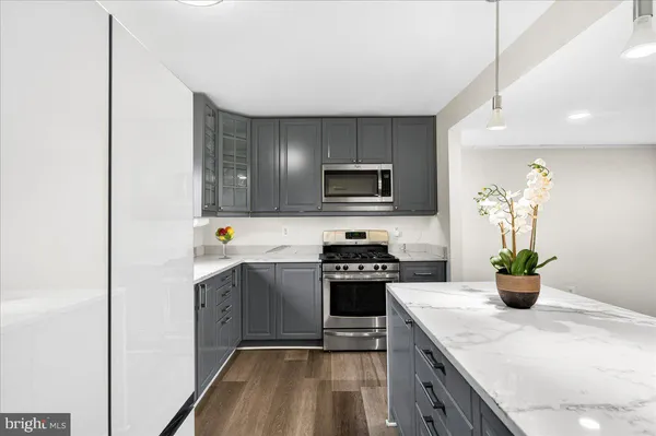 a kitchen with a sink a stove and cabinets