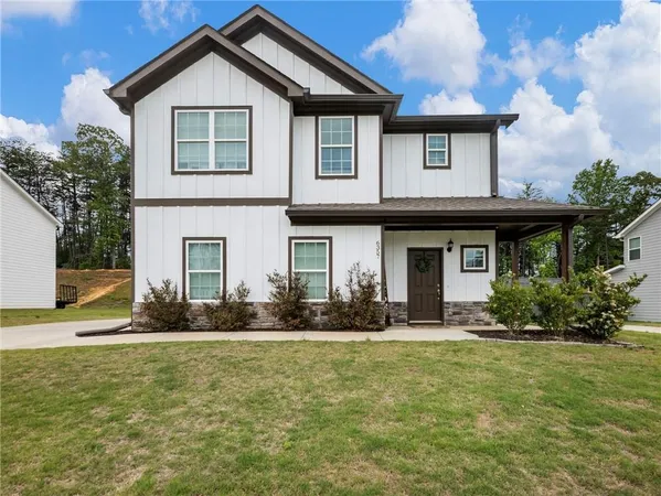 a front view of a house with a yard