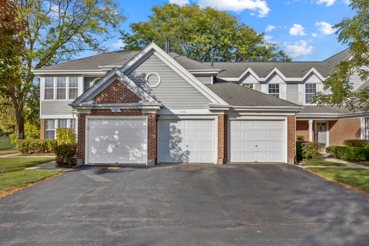 148 White Branch Court Buffalo Grove, IL 60089 - Photo 2 of 25 a front view of a house with a yard