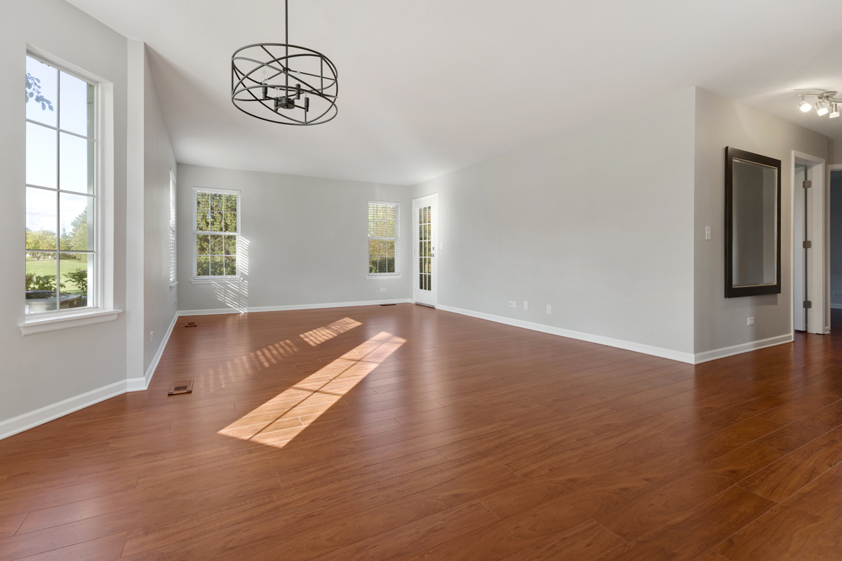 148 White Branch Court Buffalo Grove, IL 60089 - Photo 6 of 25 an empty room with wooden floor and windows