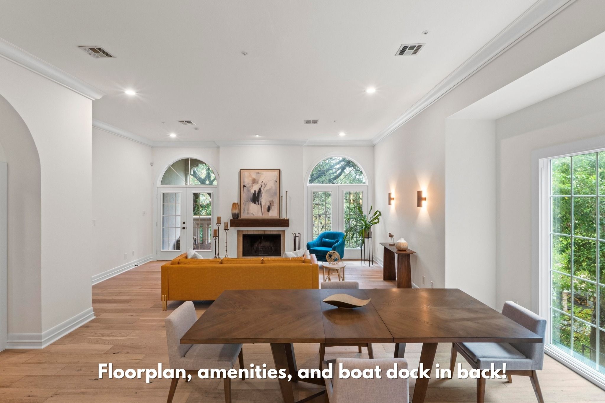 1937 Rue De St Tropez, Unit 5 Austin, TX 78746 - Photo 1 of 1 Dining area featuring light wood finished floors, ornamental molding, a fireplace, healthy amount of natural light, and arched walkways