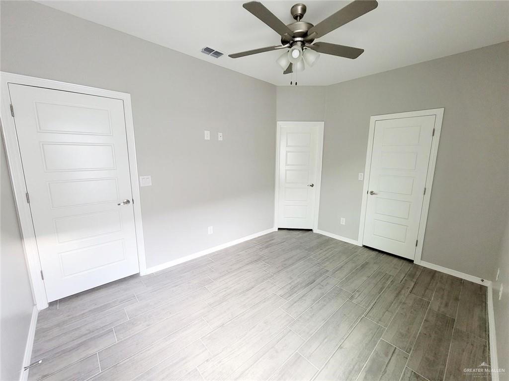 2109 Davenport Street, Unit 3 Weslaco, TX 78596 - Photo 13 of 15 an empty room with wooden floor closet and windows