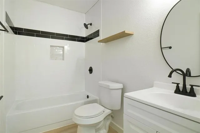 a bathroom with a sink a toilet and a bathtub