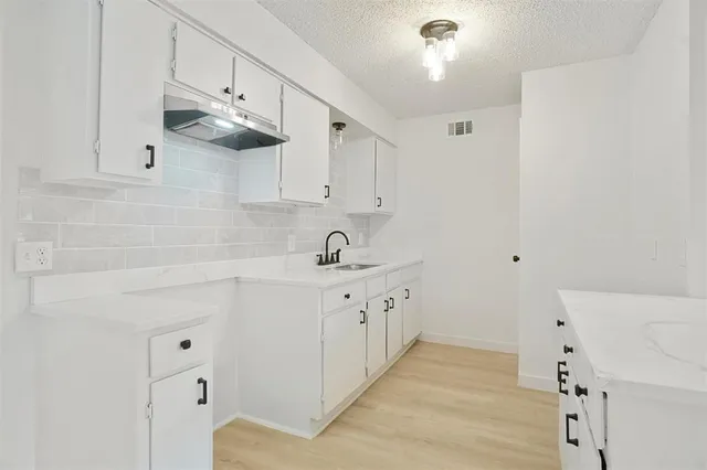 a kitchen with cabinets and window