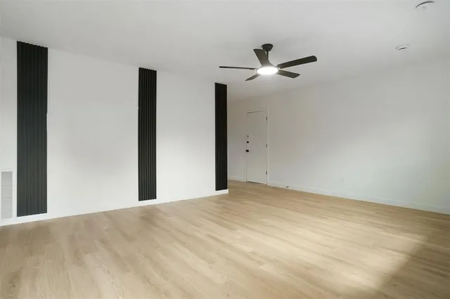 a view of a big room with closet and ceiling fan