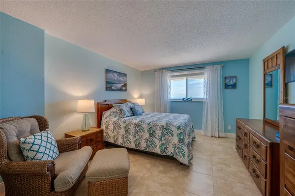 a bedroom with a bed and dresser