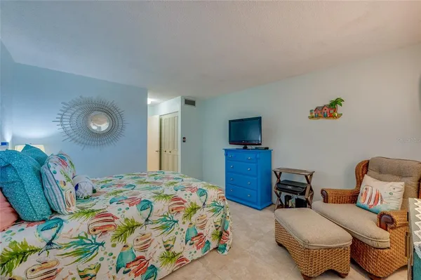 a bedroom with a bed and a television