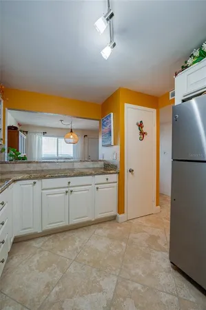 a kitchen with refrigerator and window