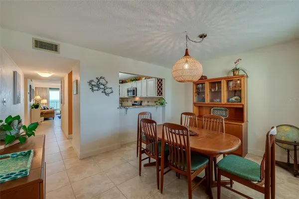 a dining room filled chandelier and wooden floor