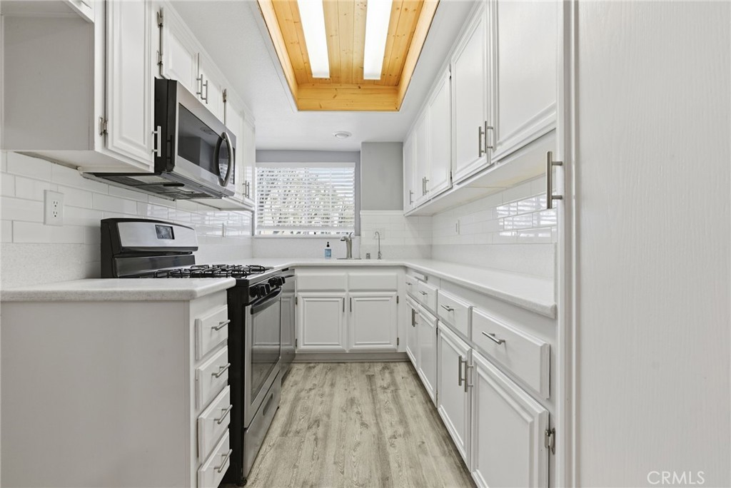 8594 Shramsburg Drive Rancho Cucamonga, CA 91730 - Photo 16 of 43 a kitchen with stainless steel appliances granite countertop a sink and a stove