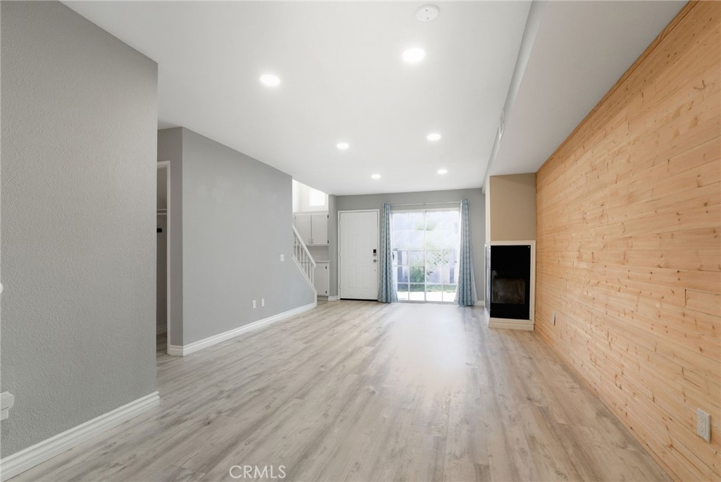 8594 Shramsburg Drive Rancho Cucamonga, CA 91730 - Photo 18 of 43 a view of a big room with wooden floor and windows