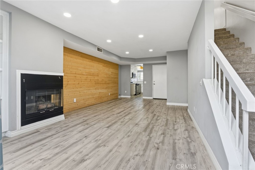 8594 Shramsburg Drive Rancho Cucamonga, CA 91730 - Photo 19 of 43 a view of an empty room with wooden floor and a fireplace