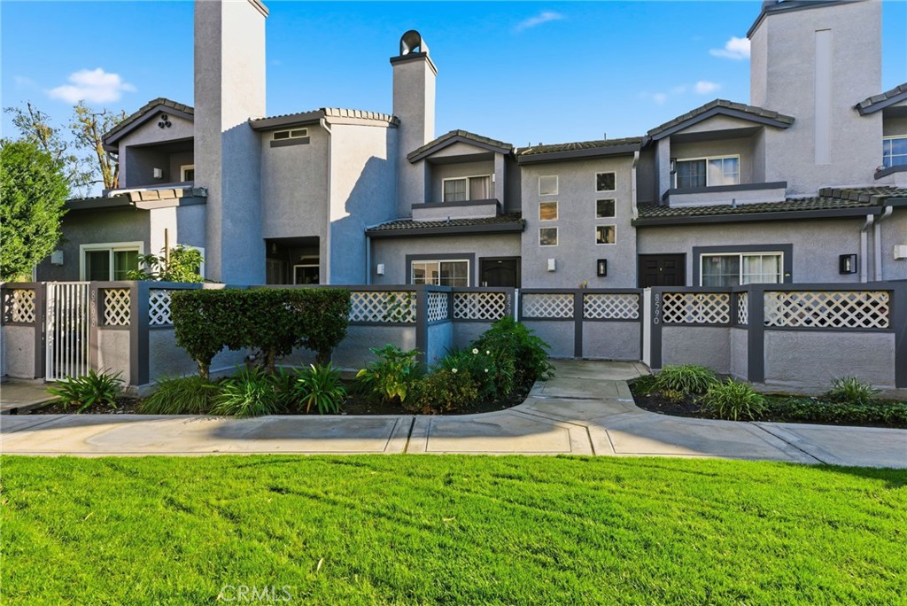 8594 Shramsburg Drive Rancho Cucamonga, CA 91730 - Photo 2 of 43 a front view of a house with a yard and garage
