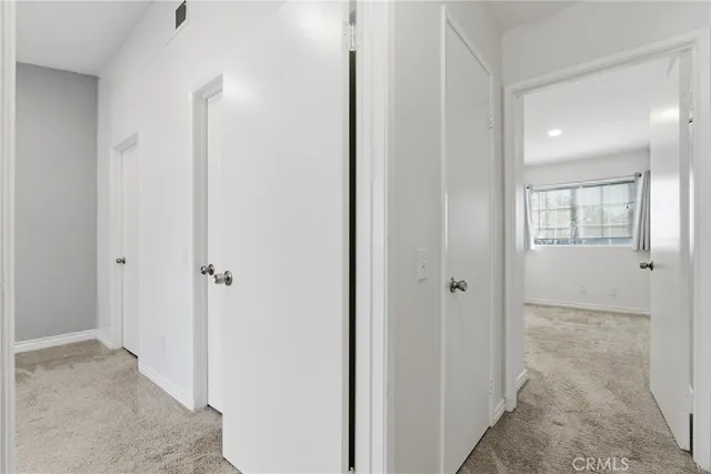 a view of a hallway with two rooms