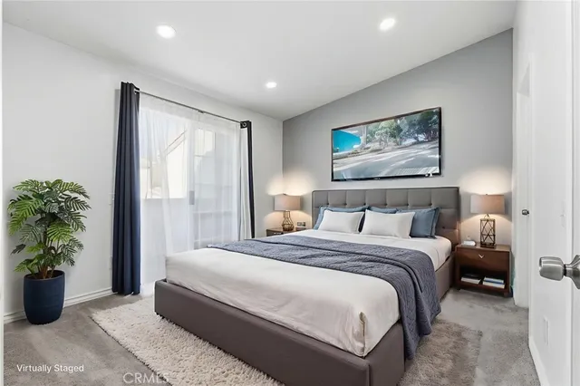 a bedroom with bed and a potted plant