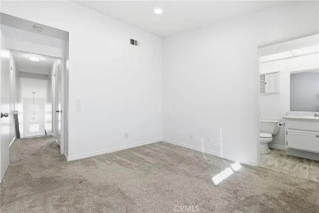 a bathroom with a sink toilet vanity and shower