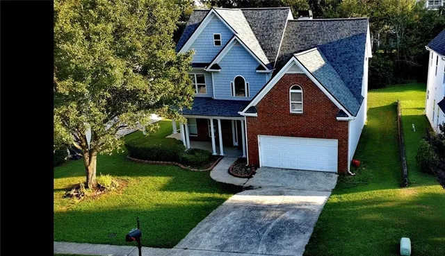 a front view of a house with garden