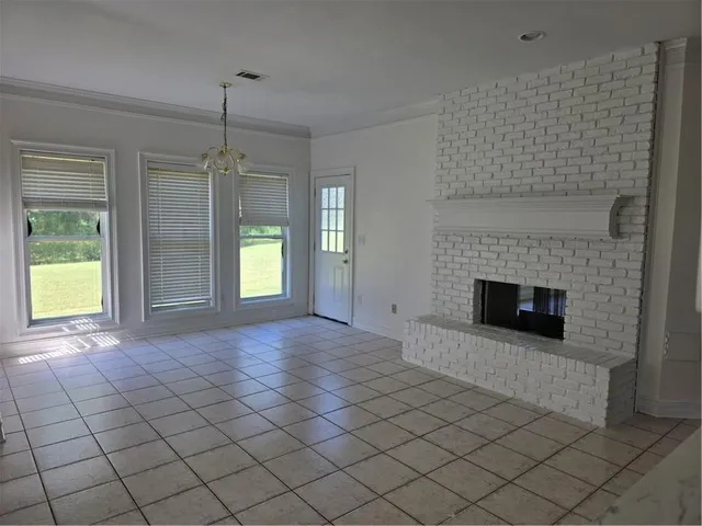 a view of empty room with wooden floor and fireplace