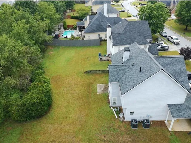an aerial view of a house with a swimming pool