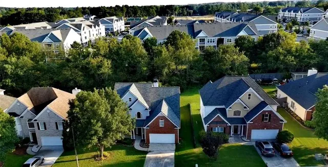 an aerial view of multiple houses with yard