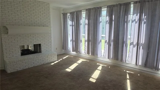 a view of empty room with floor to ceiling window