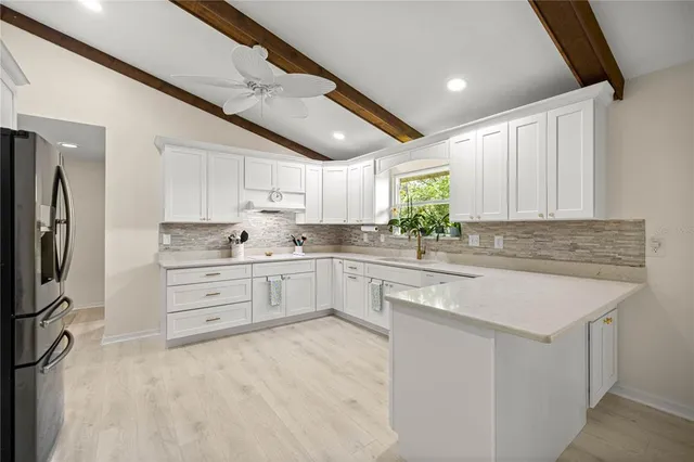 a kitchen with granite countertop a sink stainless steel appliances and cabinets