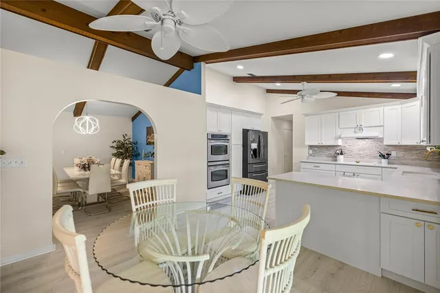 a kitchen with stainless steel appliances kitchen island granite countertop a sink and cabinets
