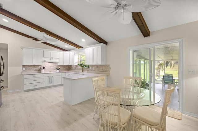 a kitchen with white cabinets and white appliances