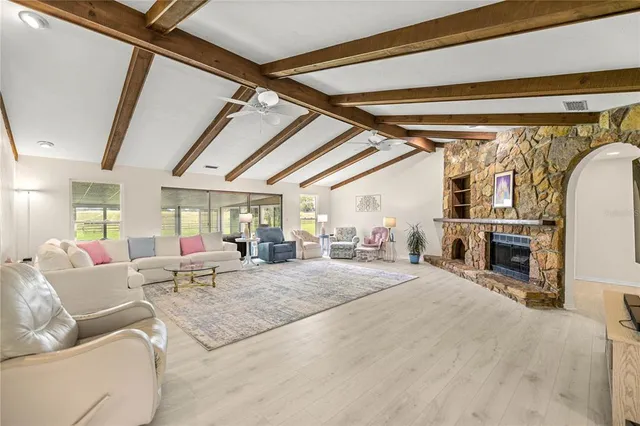 a living room with furniture a fireplace and a flat tv screen