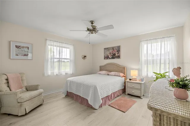 a bedroom with a bed couches and window