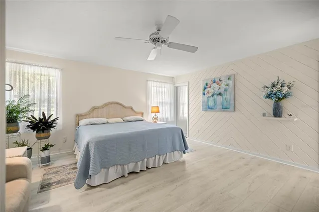 a bedroom with a large bed and a chandelier