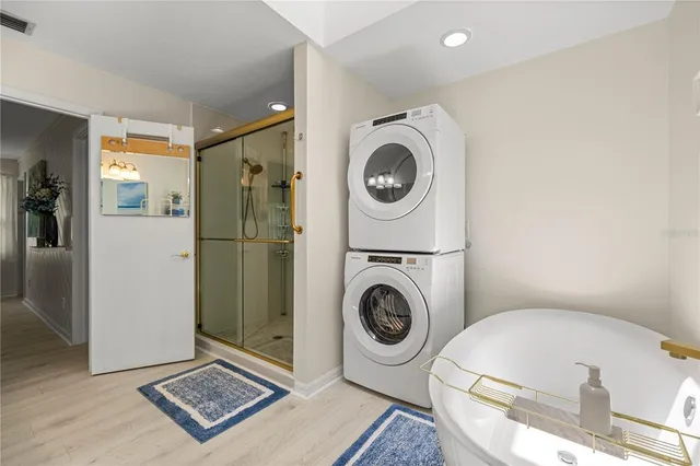 a view of a storage and utility room with washer and dryer