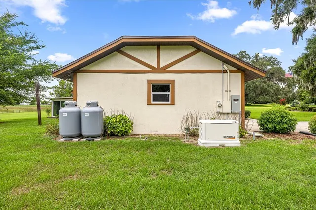 a view of a house with a yard and sitting area