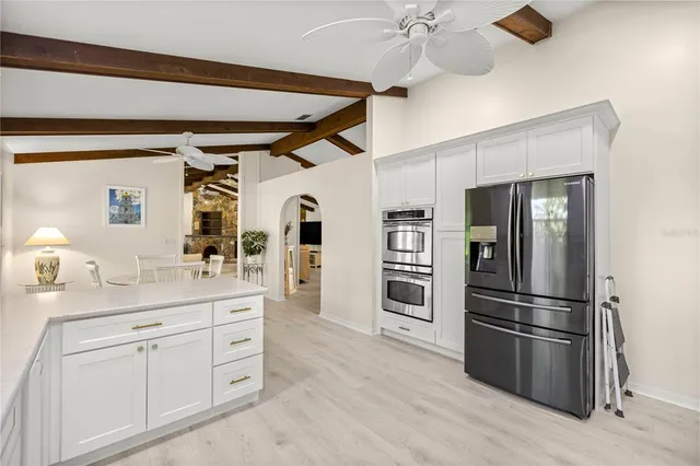 a kitchen with stainless steel appliances a refrigerator and a stove top oven